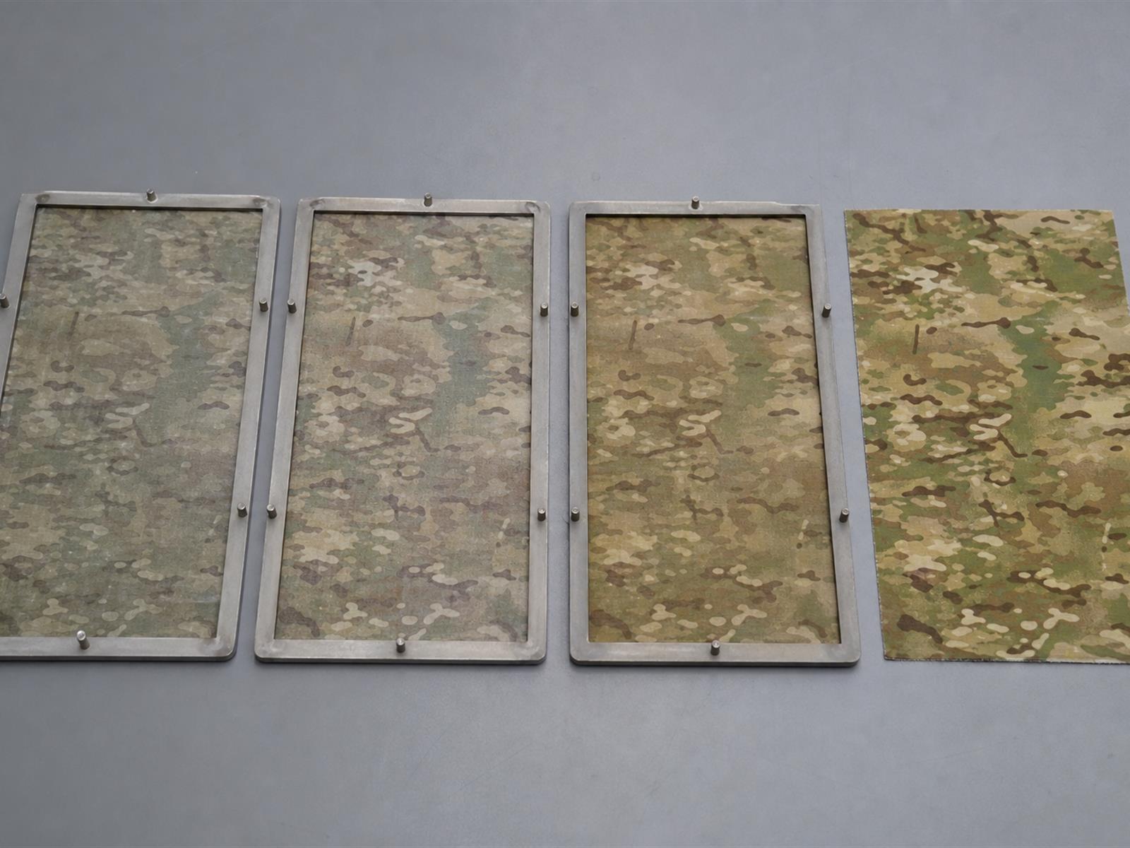 Colour retention test specimens beside unexposed camouflage reference fabric in the Field Lab