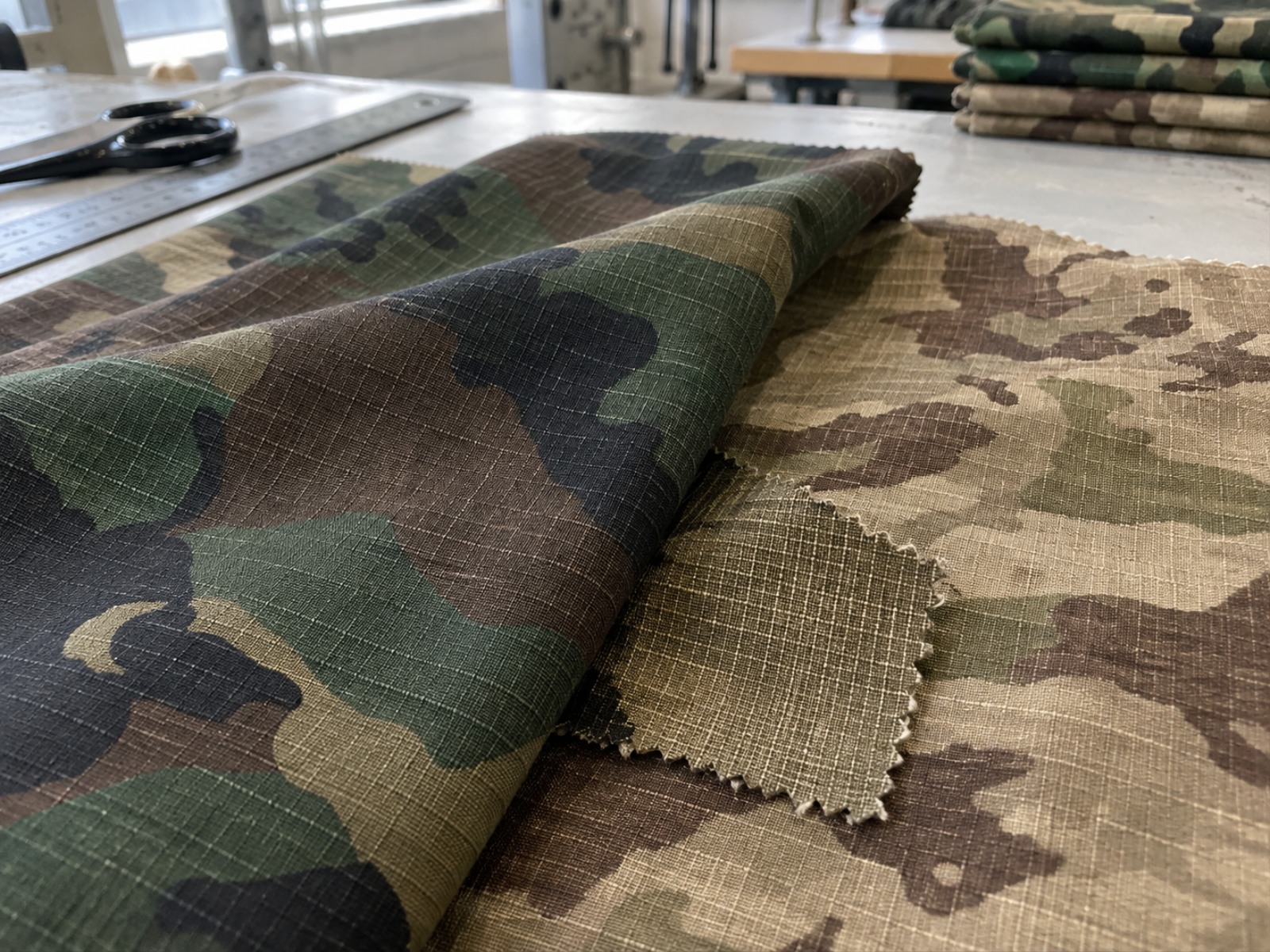 Macro view of cotton ripstop fabric showing the ripstop grid and natural cotton fibre texture