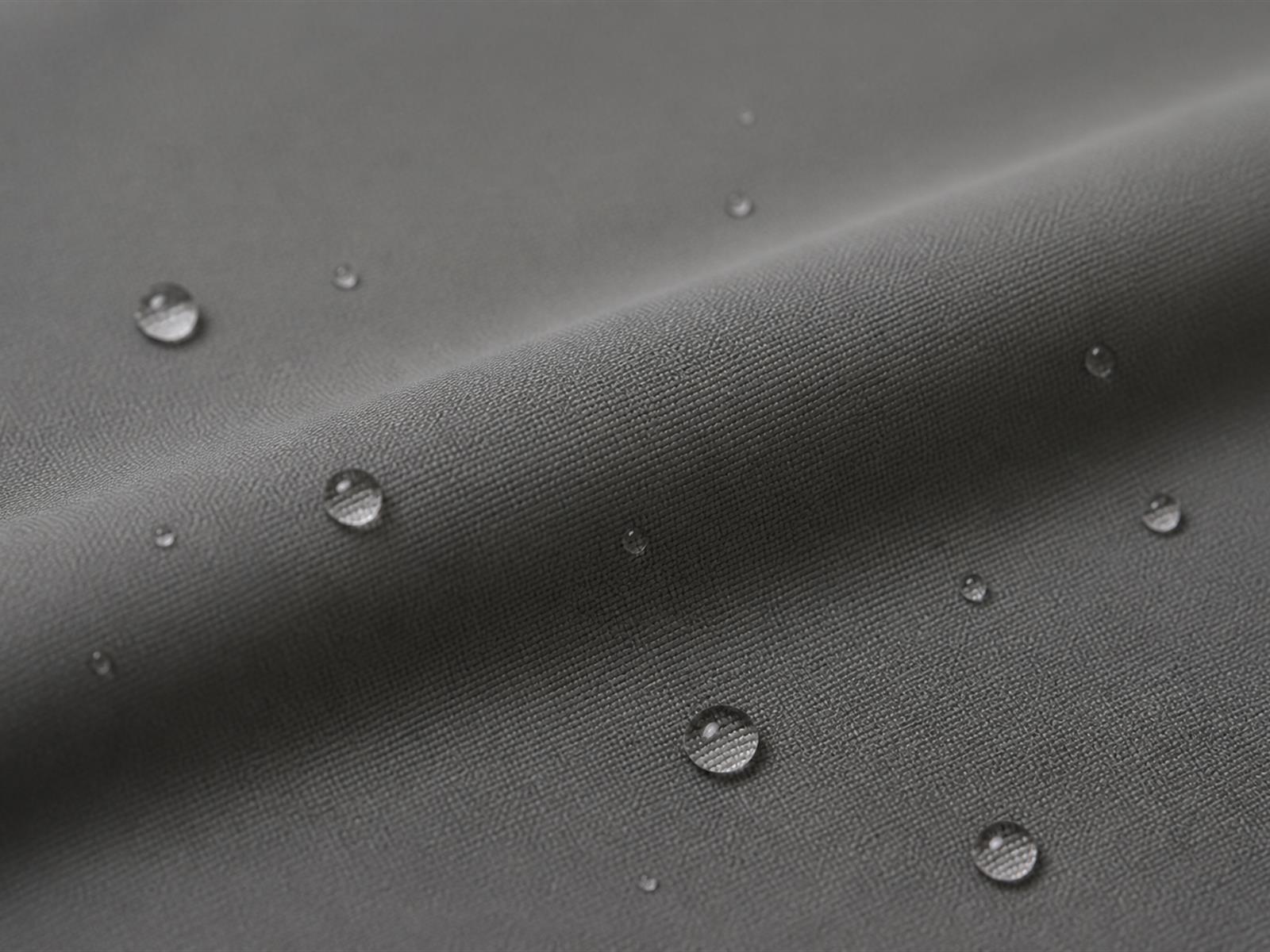 Macro view of water resistant fabric showing water beading on the surface of tactical jacket fabric